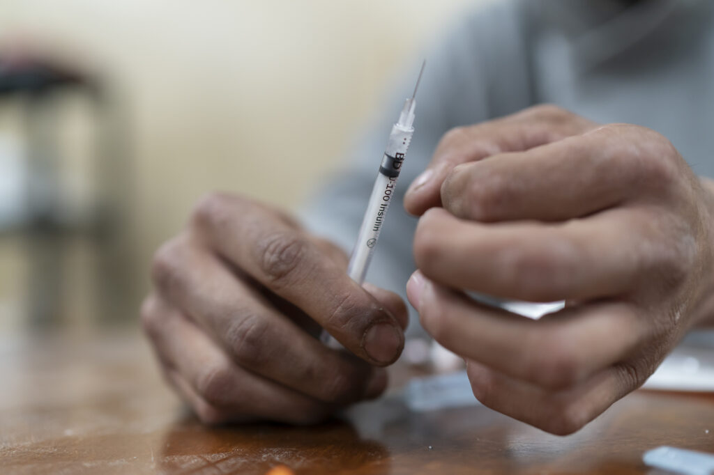 A man prepares to inject methamphetamine in Ahtahkakoop.